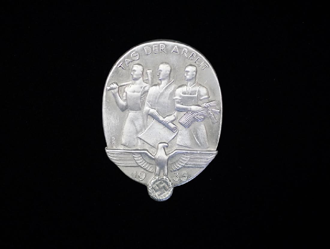 German 1935 Tag der Arbeit Badge: German 3rd Reich badge dated 1936; 45mm die stamped aluminum alloy badge with pin-back; maker marked reverse -mint condition.