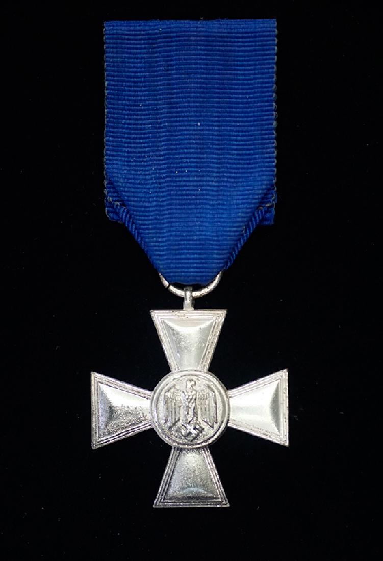 WWII German Wehrmacht 18 Yr Service Medal: German WWII Wehrmacht 18 Yr Long Service Medal; silvered cross retaining 97% finish on original blue ribbon; for Heer, Luftwaffe & Kriegsmarine Service -near mint condition.
