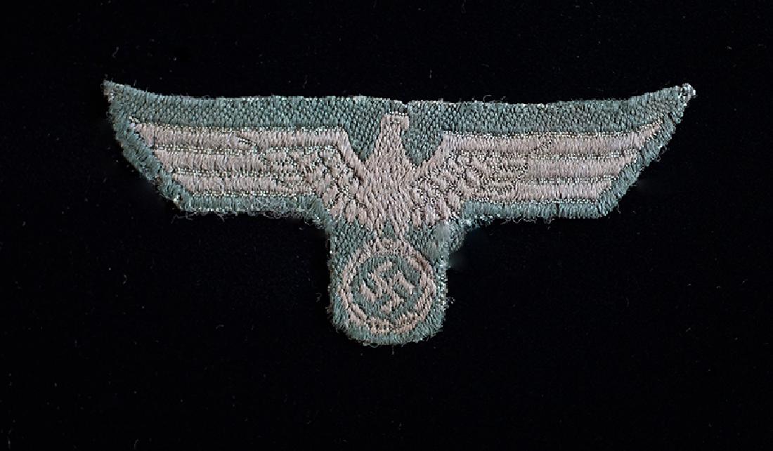 WWII German Army Enlisted Cap Eagle: WW2 Army enlisted Cap Eagle; gray bevo-woven on green for M43 Field & Overseas Caps; cap remvoed; very good+