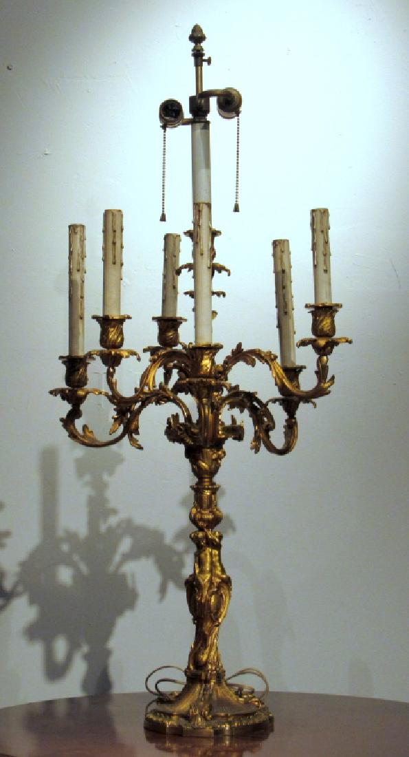 French Bronze Candelabrum Lamp: 2 lights and 6 non-wired candle arms in Rococo style. Putti figural post. 17"dia X 38"h. (From a Central Park West Estate)