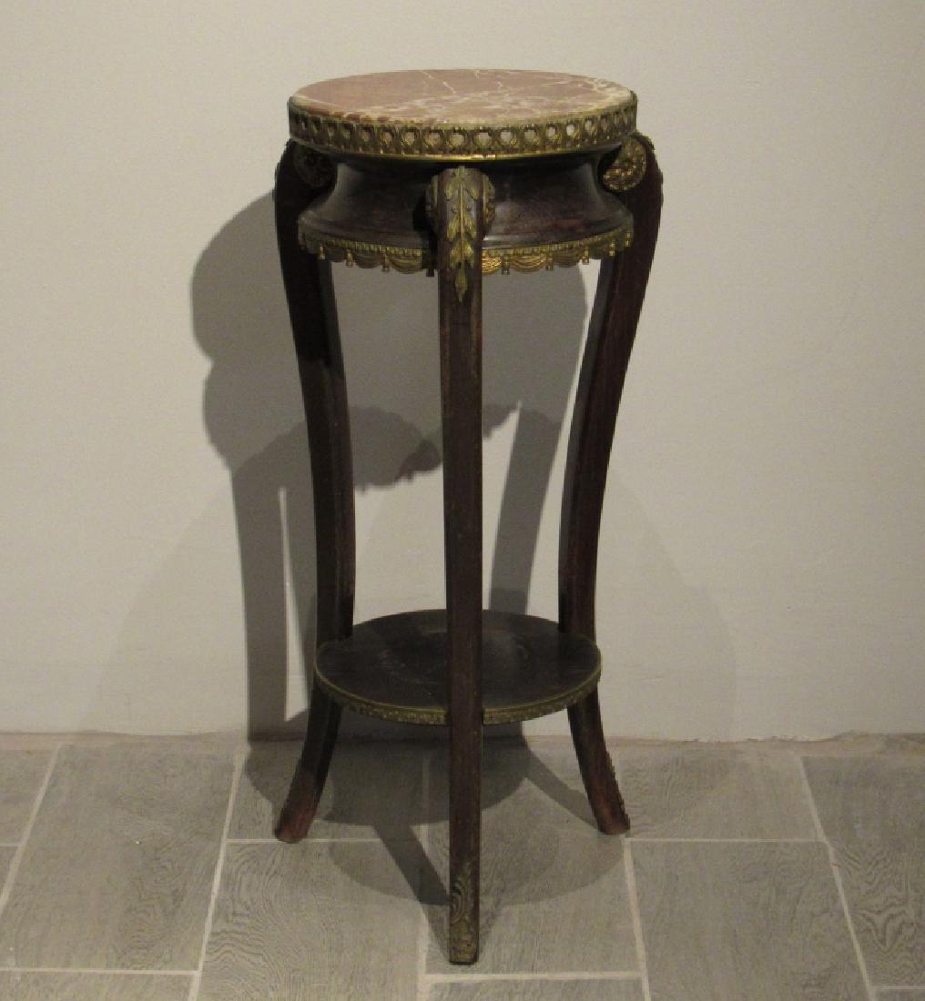 Louis XV Style Pedestal: Inset marble top on gilt metal mounted wood stand with lower tier. Sloping legs. 13"dia X 28"h.