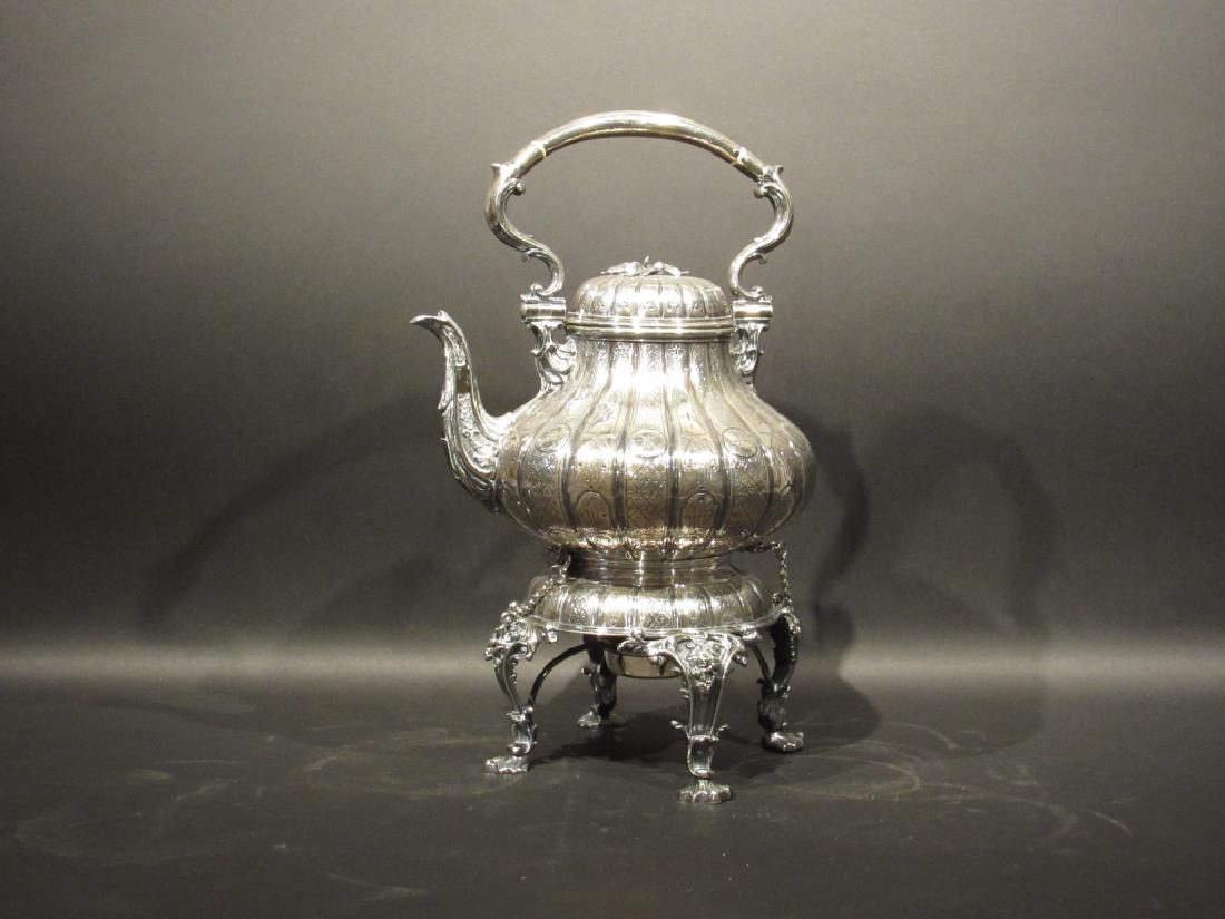 English Silver Plated Kettle on Stand: All over repousse design with handle, scrolling legs to pad scroll feet. Pin for kettle tilt. Hallmarks on bottom. 10"dia X 16"h
