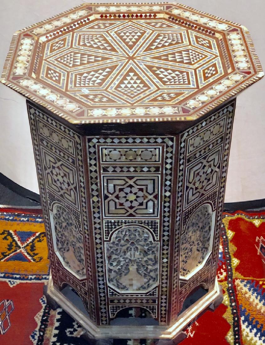 An Octagonal Shaped Syrian Inlaid end Table: A finely carved a mother of pearl and rosewood inlaid Syrian center or end-table. 22" D 27"H. Good condition.