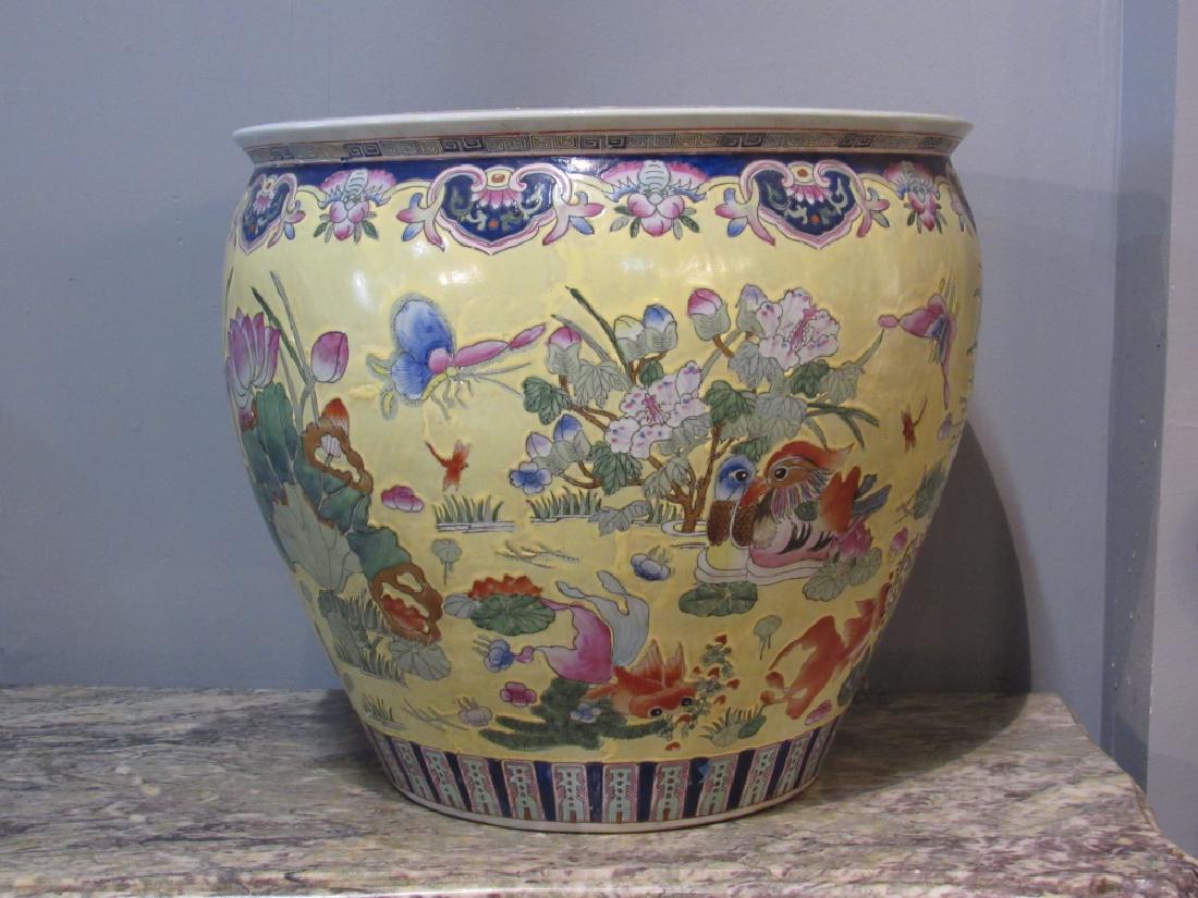 Large Chinese Porcelain Fish Bowl: Large Chinese porcelain fish bowl interior and exterior enameled design of fish, flowers, crickets etc. Signed on bottom. 24"D 20"H.