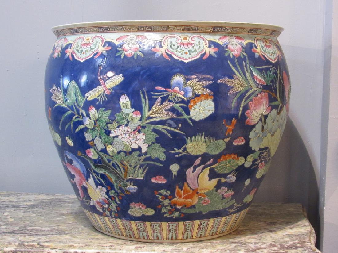 Large Chinese Porcelain Fish Bowl: Large Chinese porcelain fish bowl interior and exterior enameled design of fish, flowers, crickets etc. Signed on bottom. 24"D 20"H.