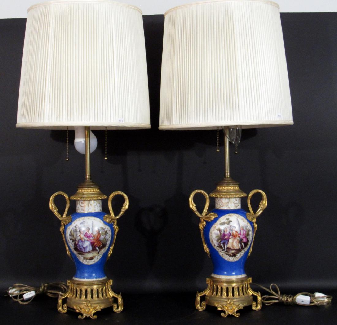 Pair Sevres Style Vase Lamps: Gilt ormolu bronze mounts with painted courting scene panels on Robin's egg blue ground. With shades. 8"dia X 26" (non-extended) finial.