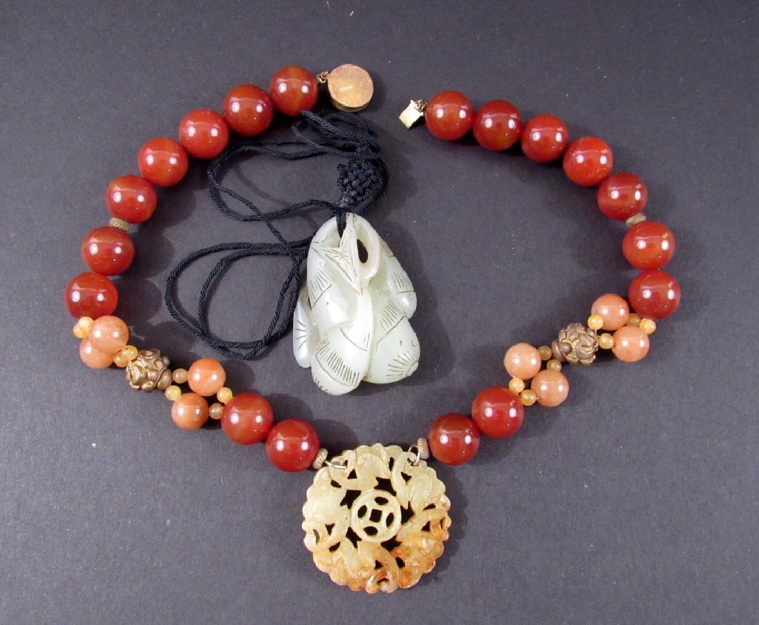Chinese Jade Necklaces: Russet jade pendant on carnelian and sterling silver mounted necklace, Jade toggle on string.