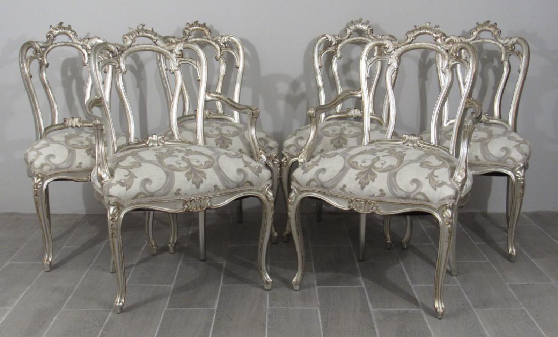 Set of 6 Italian Rococo Manner DIning Chairs: Silvered carved wood scrolling headrails, open backs, beautifully upholstered. Some age cracks. 2 Arm and 4 sides. Arm: 25" X 25" X 40" (21" seat height).