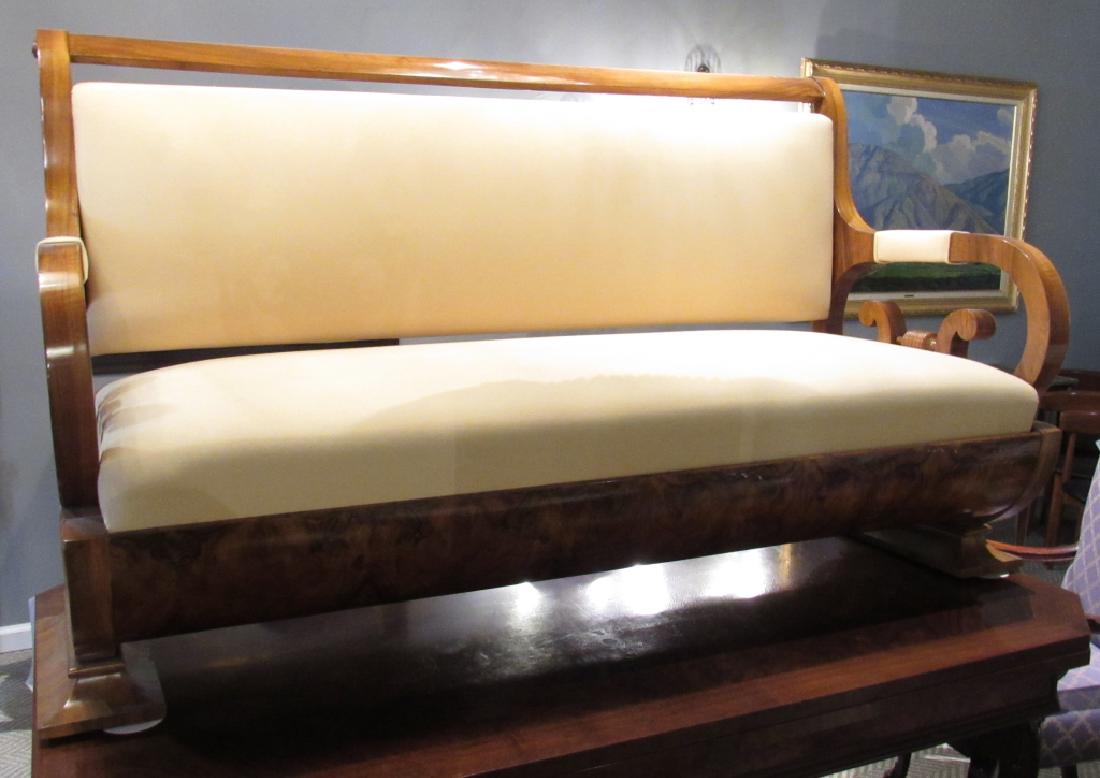 Biedermeier Sofa: Double underscroll arms curved posts on flared bases. Slight water damage to veneer on side base. 70"w X 30"d X 40"h.