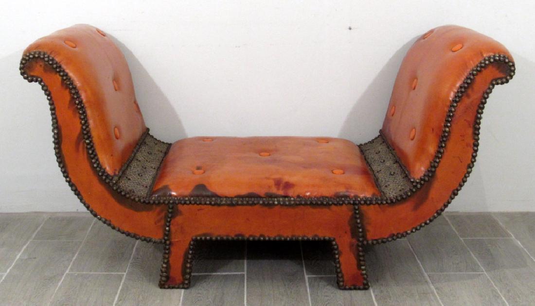 Middle Eastern Sultan: Sultan's roll arm or wide arm throne, nail head studded orange tone distressed leather and decorative metal trim off seat. 56"w X 25"d X 30"h