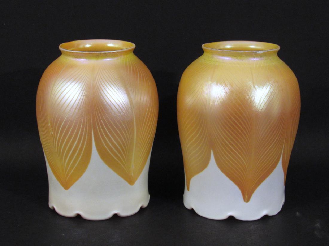 2 Quezal Art Glass Shades: Gilt pulled feather on white, sculpted tops, gilt iridescent interiors. 3.5"DIA X 2.25"bases X 4.75"h. One base minor chip.