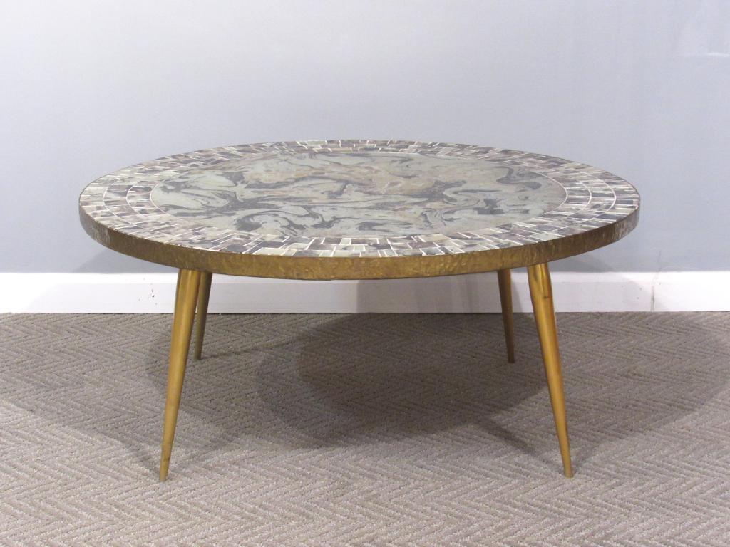 Mosaic Mirrored Top Coffee Table: Eglomise circular top with mosaic eglomise tile border, hammered metal trim. Gilt metal screw in legs. 36"diam X 16"h
