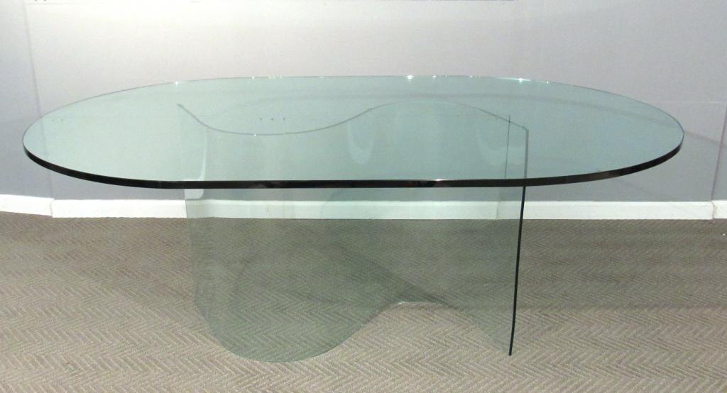 Modern Glass Top Glass Base DIning Table: Oval shaped glass top sits atop serpentine shaped base, 73.5"w X 46.75"d X 28.5"h