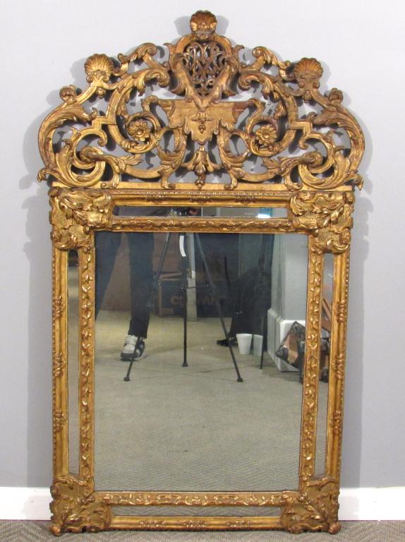 Antique French Regence Mirror: Gilt carved wood mirror decorated with shell, acanthus leaves, and flowers. 31"W X 51"H. (Staten Island Private Collection)