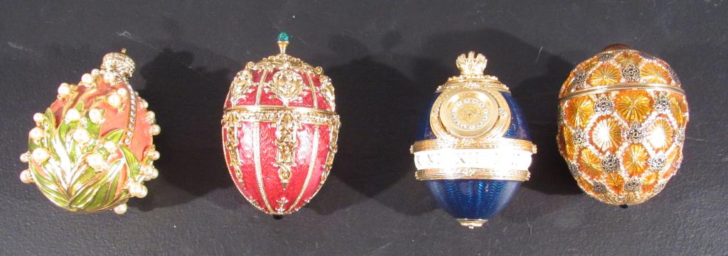 4 Enameled and Jeweled Eggs: Pink and green with crown; red and green with mini; blue enamel Joan Rivers clock; yellow enamel Joan Rivers box. Tallest 3.5". (Staten Island Private Collection)