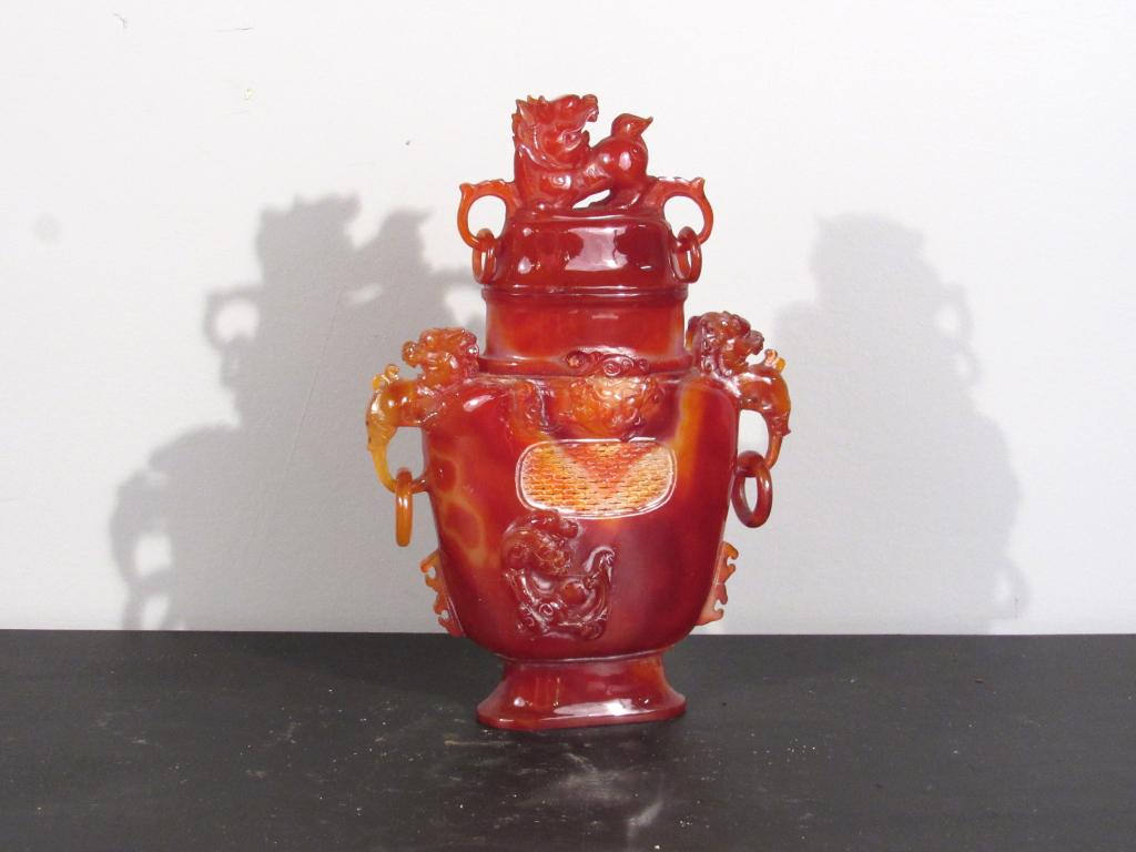 Chinese Carnelian (?) Covered Jar: Foo lion cover with ring mounted handles. Open fret front and back. 7.5" X 2.5" X 11". (Staten Island Private Collection)