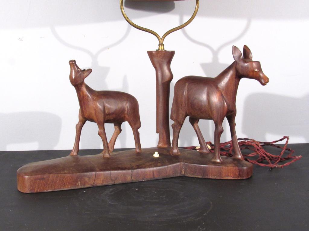 Mid Century Carved Wood Table Lamp: Wooden carved pair of animals base, one animal missing antlers. 20" X 6" X 24"H (15"dia X 35"H with shade)