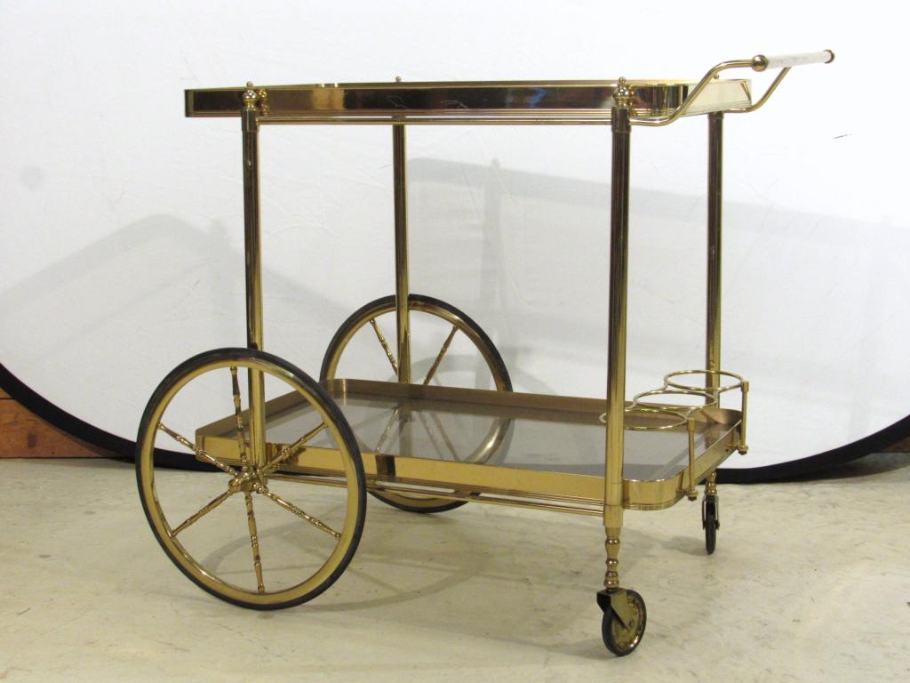 Mid Century Style Brass Bar Cart: Inset smoky glass tops, handle, and bottle holders. Strong condition. 31"W X 20"D X 26"H.
