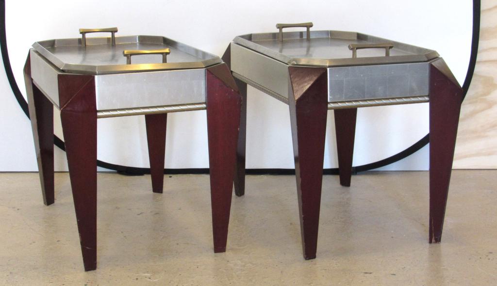 Pair Dakota Jackson Butlers Tray Top Stands: Brushed metal octagonal separate trays on silver leafed wood, with geometric angular mahogany legs. Brushed metal rope twist trim. One tray dent, one leg split at bottom. Tray 32" X 20" - Stand 33" X