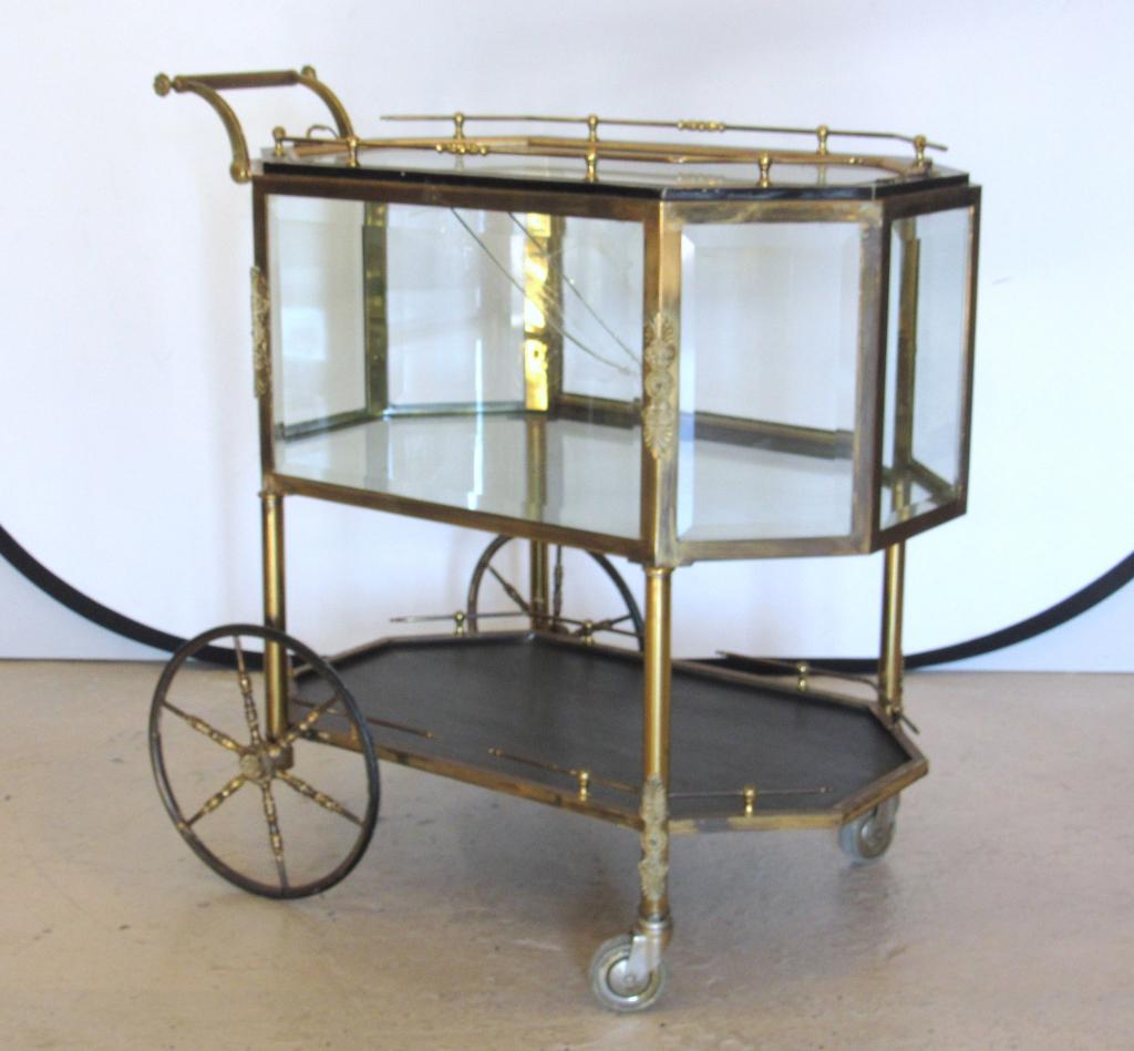 French Style Mixed Metal Serving / Vitrine Cart: Beveled glass all round (one broken) with 3/4 gallery removable tray top, glass enclosed body and lower 3/4 gallery wood tier. Bronze frame with gilt metal mounts. 36" X 20" X 34"h.