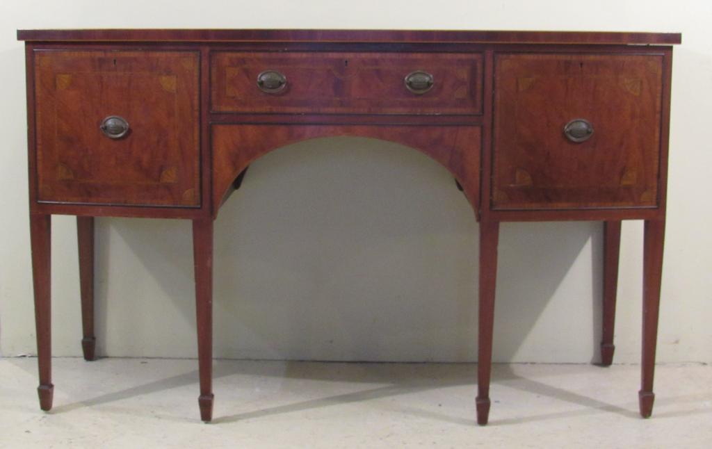 Schmieg & Kotzian Bow Front Sidebaord: Mahogany top over line inlaid, cross banded and fan cornered mahogany fronts. Left door shelved, center fitted drawer and right door with interior drawers. Straight tapered legs. 60" X 23" X 36.5"h