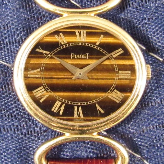 Piaget 18K Gold Ladies Wrist Watch: Roman numerals on Tiger's Eye face, hallmarked with band loops marked Piaget 750.