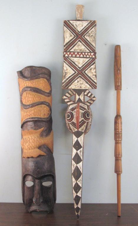 3 Carved African Articles: Masks and shield and spear (?). Longest 56"
