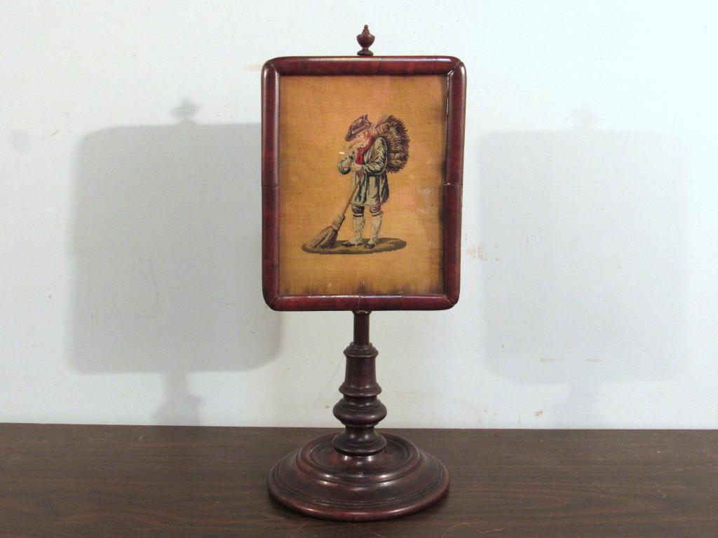 Antique English Table Top Pole Screen: Inset needlepoint picture of a man, turned mahogany base. 6" dia X 15"h (A North Salem, NY Estate)