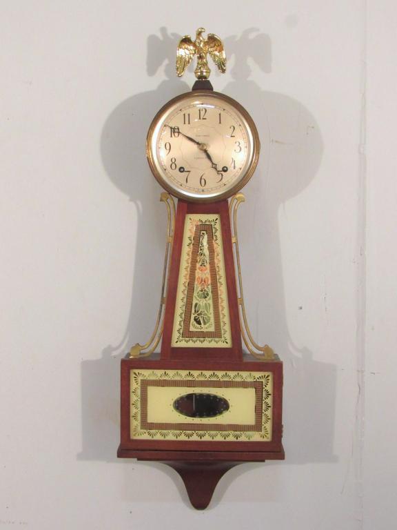 Seth Thomas for Tiffany 8-Day Wall Clock: Eagle finial above metal face with convex glass, interior with pendulum and key. 10" X 4.5" X 30" (A North Salem, NY Estate)