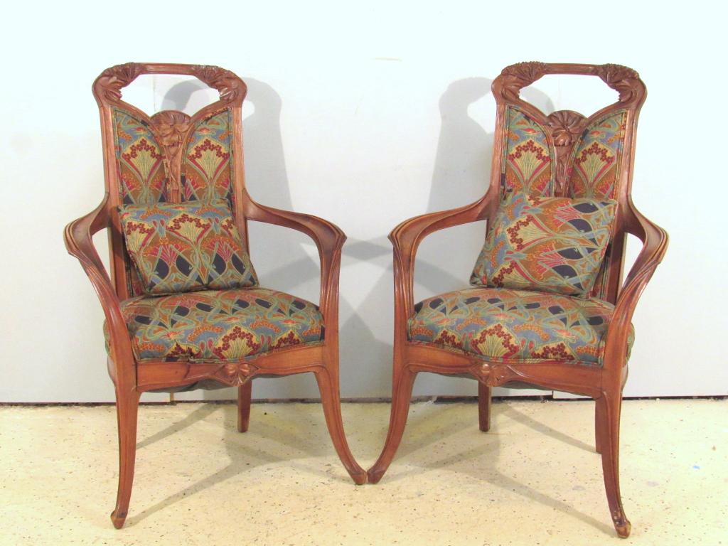 Pair Louis Majorelle Arm Chairs: Finely carved tree corners and floral backs, finger molded arms. Split in one front skirt. Some cracks consistent with age. Nicely upholstered in period style fabric. 28" X 26" X 43"h (A Tarrytown NY 