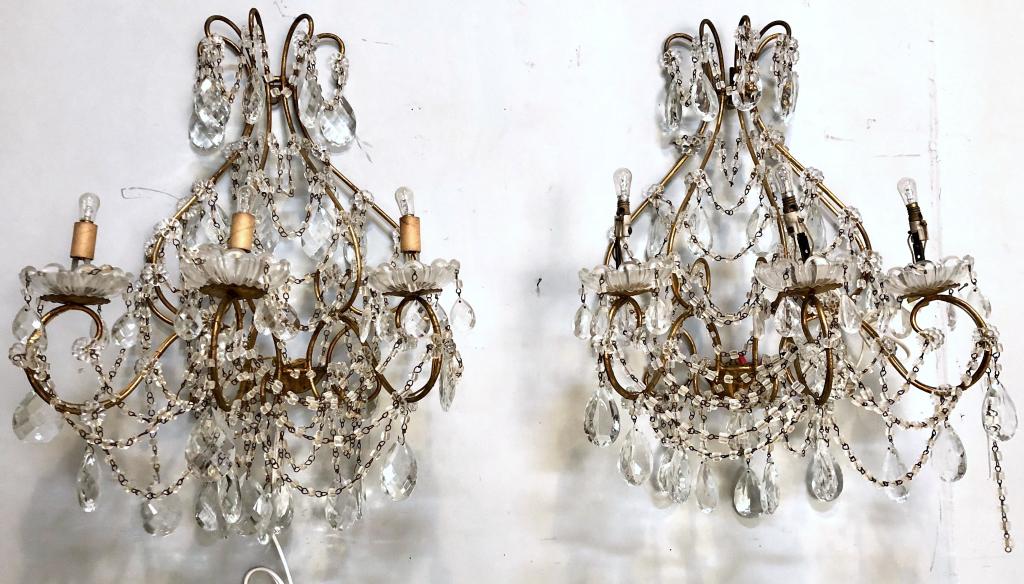 Pair Hollywood Regency Style Sconces: Gilt metal with beaded trim and crystal prisms, 3 arms with glass bobeches. 21" X 12" X 24"h (From a Watertown CT Estate)