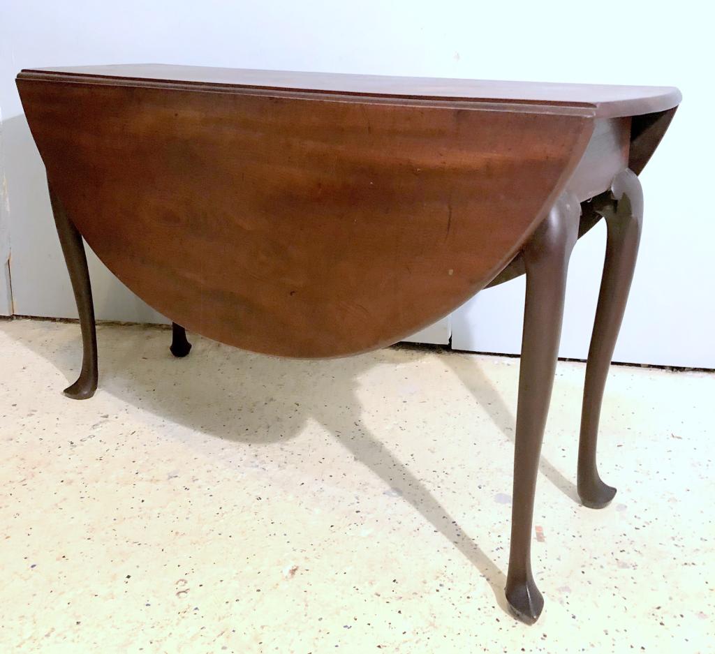 Antique American Drop Leaf Dining Table: Mahogany table with demi lune drop sides, opening to a round table. 50" (dia) X 17" X 29"h (A North Salem, NY Estate)