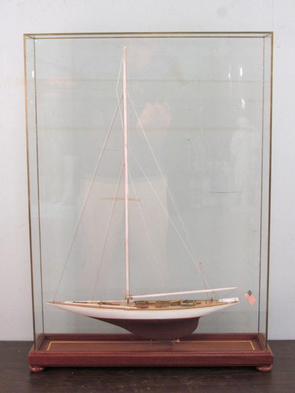 Ship Model of an American Schooner Yacht: Fully roped single mast, flying American flag on finely detailed deck. In glass case. 21" X 5.5" X 28.5" (From a Greenwich CT home)