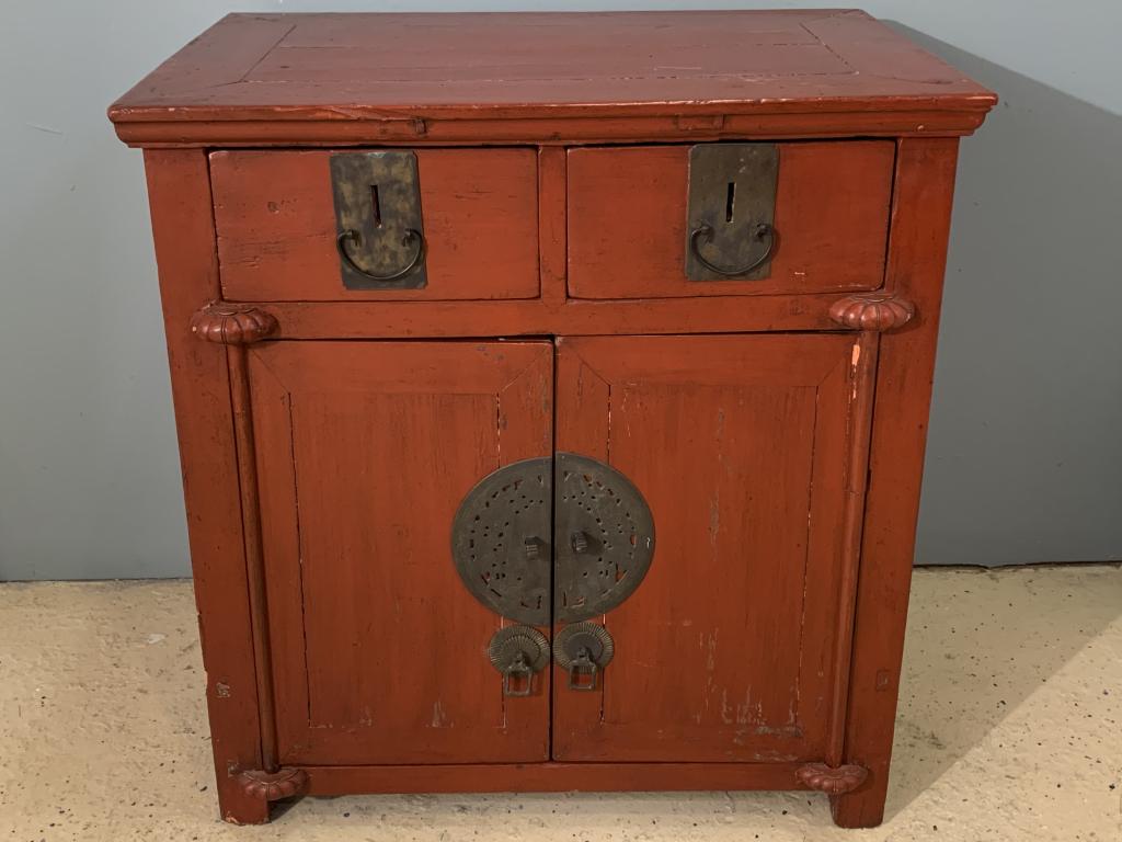 An Asian Cabinet or Nightstand: A red paint decorated antique cabinet. Original hardware. W 30.5" D 19" H 33"