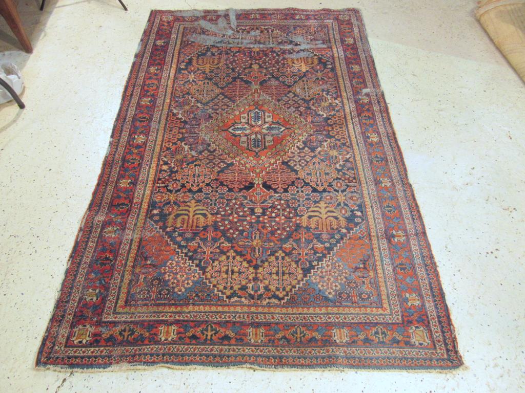 Oriental Rug - 4' 2" X 6' 10" (as is): Multi colors with tree and other form rosettes. Worn and washed away areas / losses.