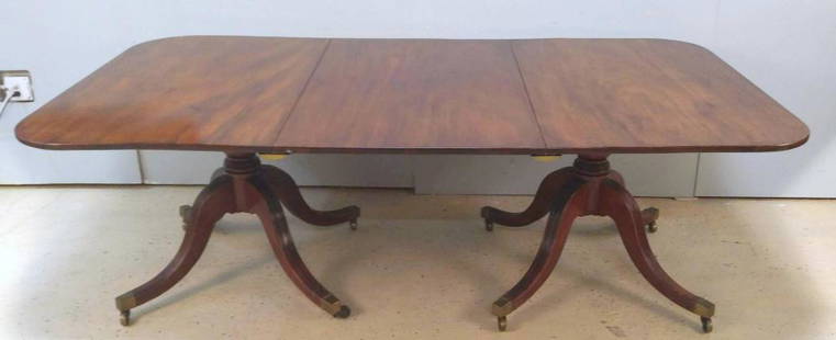 Antique English Double Pedestal Dining Table: Mahogany, quad pod splay leg bases on castors. Solid top. Brackets not original, will only set with 1 leaf in. Retailed by Norman Adams, London. 48" X 87" X 28.5"h