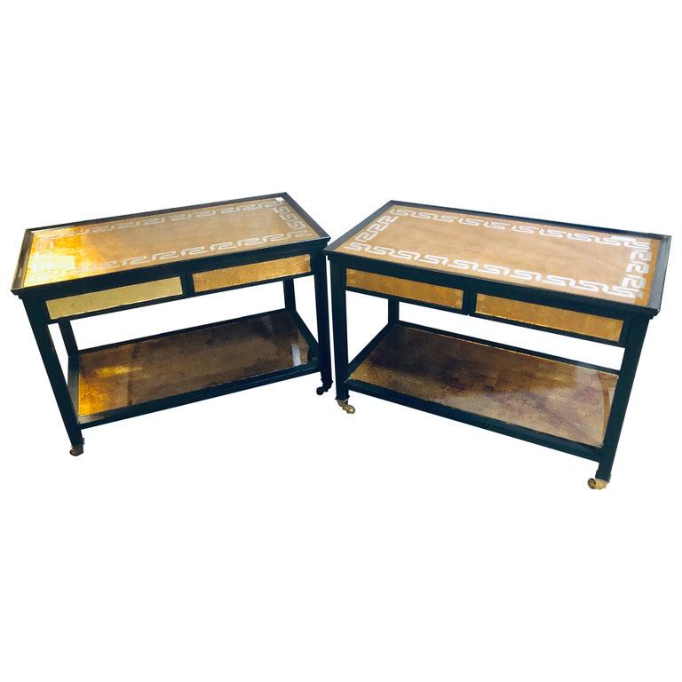 Pair Greek Gilt Mirror 2-Drawer Serving Tables: In the manner of Jansen. Each has a lower gilt glass Greek key designed lower shelf under a pair of mirrored front drawers and a Greek key designed glass tabletop. Hollywood regency style, finished on