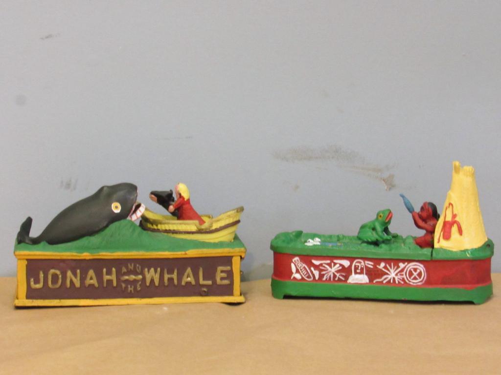 2 Reproduction Iron Painted Banks: 1 depicts Jonah and the Whale. 1 depicts Chief Big Moon feeding a fish that brings frog jumping out of the water. Made in Taiwan. Tallest: 10" x 3.5" x 6".