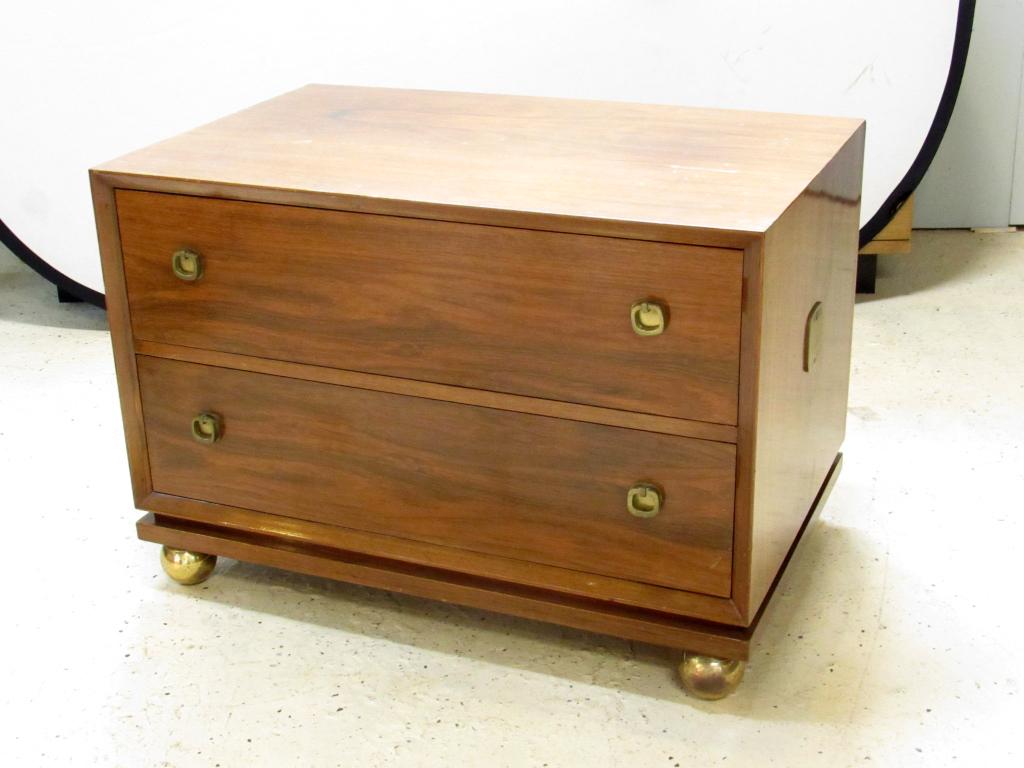 Mid Century Walnut 2 Drawer Low Chest: Brass hardware and large brass ball feet. One side handle missing. Some scratches. Manner of George Nelson. 33" X 21" X 23"h (From an 870 UN Plaza, NY Estate)