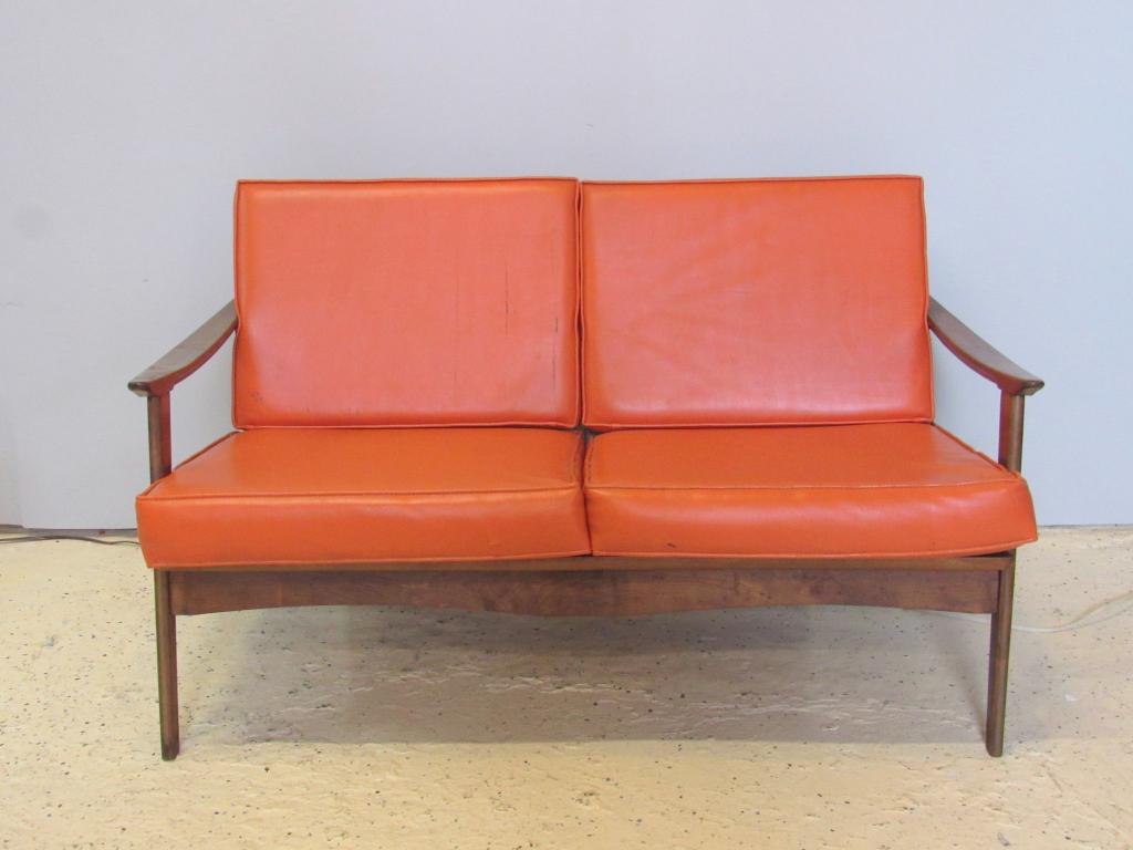 Mid Century Open Arm Love Seat: Vinyl cushions. Slopping arms and sculpted skirt. After John Stuart. 50" x 31" x 27" h