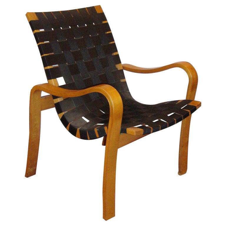 Bruno Mathsson Style Bentwood Recliner: A bentwood armchair recliner with black lattice, webbed seat support. Possibly by Bruno Mathsson. Measures: 24" x 27" x 31" Sh: 15.5" (101-795)