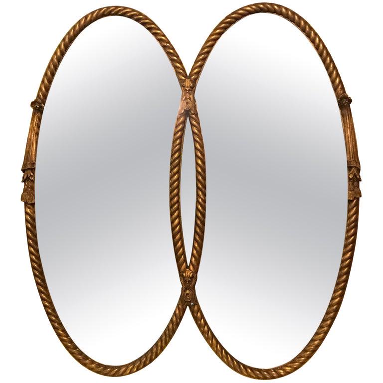 Gilt Braided Rope Edge Double Mirror: Hollywood Regency gilt braided rope edge double mirror. Wear is consistent with age. Minor fading. Measures: 43" w x 2" d x 47" h (101-2945)