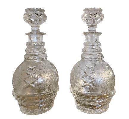 Pair of Crystal George III Irish Decanters: Grape & Leaf design. C. 1800. In great condition. Measures: 10.25" h x 5.25" dia (From a Stamford, CT Estate)Prov. Doyle Galleries NYC. We do not have staff to move items at this location. Please brin