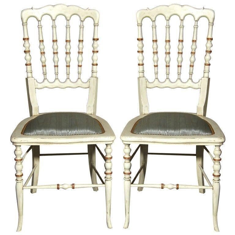 13 Spindle Back Chairs, White Paint Decorated: Set of 9 white distressed paint decorated and gilt gold Gustavian Style side chairs. Each seat with new upholstery and tacks. Price is for one chair only, please call to check the quantity.Seat height