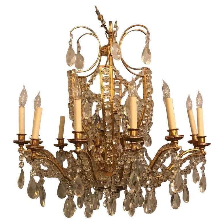 Fine Cut Crystal and Gilt Bronze Neoclassical: Fine cut crystal and gilt bronze neoclassical eighteen-light chandelier. This finely cast chandelier has six interior lights and twelve lighted outer candelabra lights. Certain to light up the largest