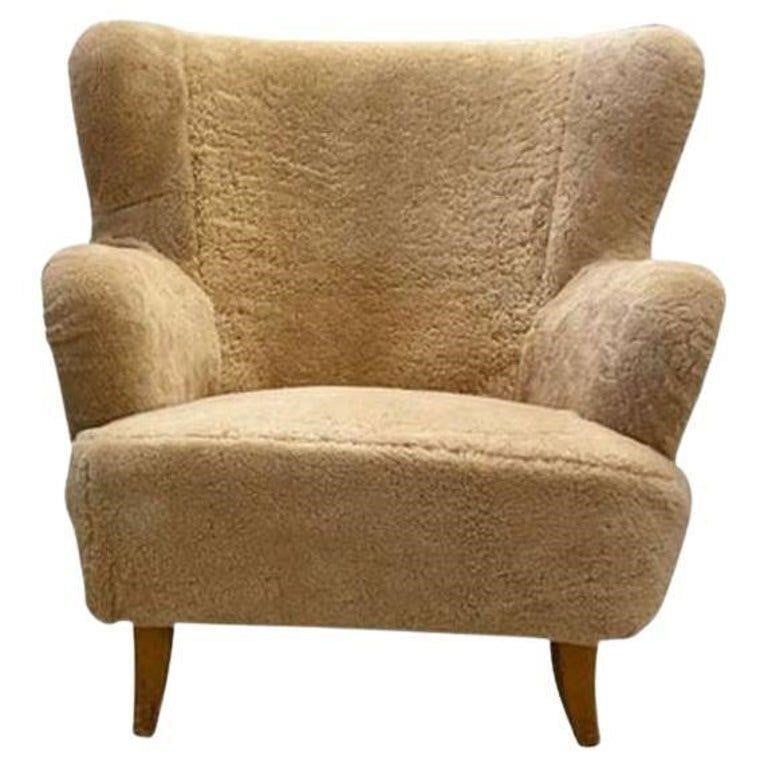 Ilmari Lappalainen Attrib., Sheepskin Lounge Chair: Newly upholstered in genuine honey sheepskin, lacquered wood legs. Attributed to Swedish designer, Ilmari LappalaineHeight: 31 in (78.74 cm)Width: 32 in (81.28 cm)Depth: 31 in (78.74 cm)Condition. Thi
