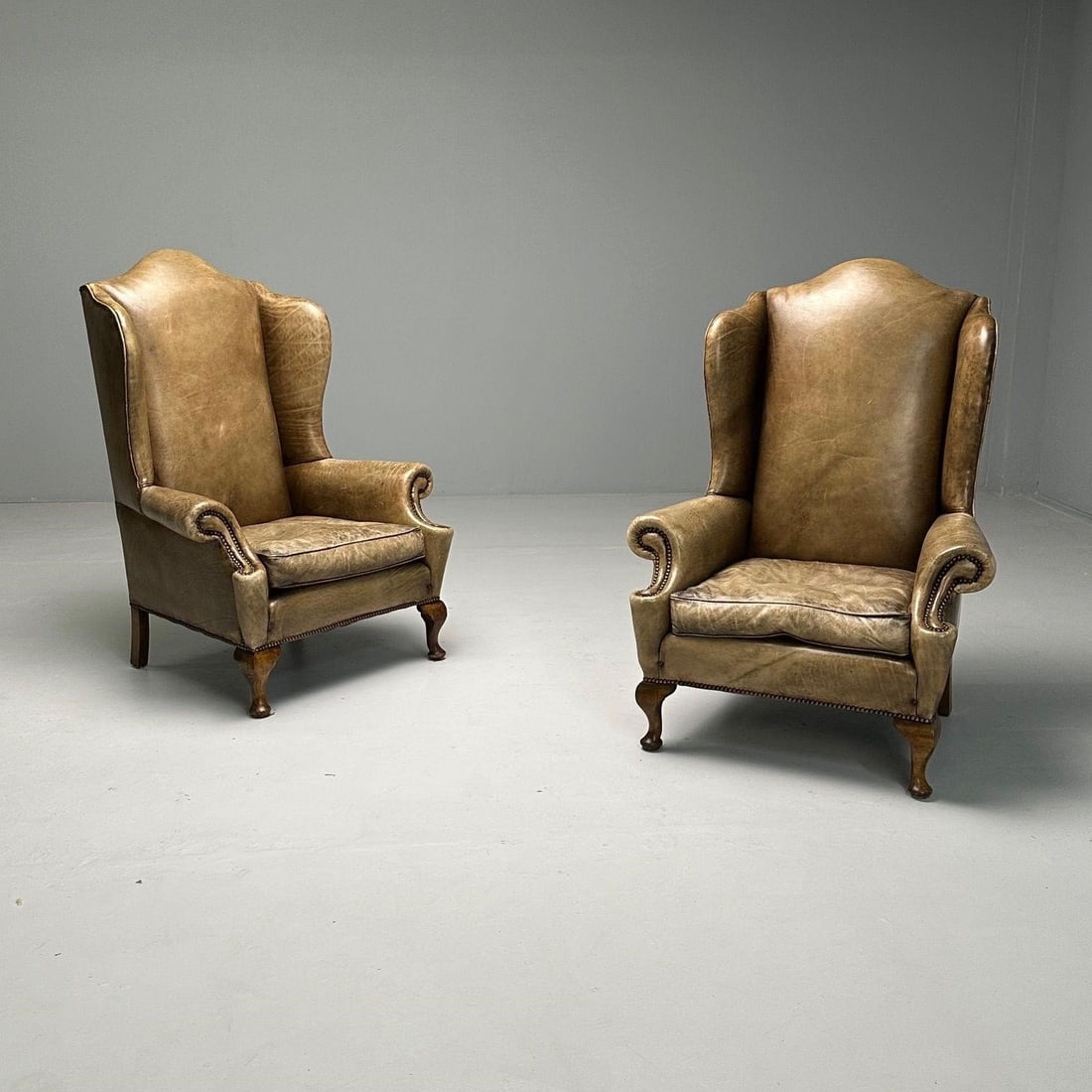 Queen Anne Wingback Brown Leather Lounge Chairs: Pair of Queen Anne Palatial worn leather wingbacksH47.5W 35.5D 34.5Sh 18