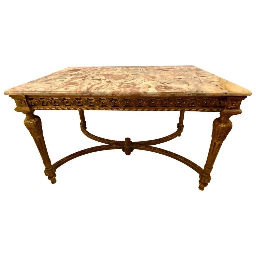 Louis XVI Marble Console Table, Jansen Style: Stamped Jansen center table having a gilt base and fine pink, grey and white veined marble-top. The top having been professionally repaired. The Louis XVI style center table having been antique guided