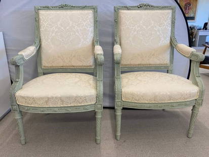 Pair Louis XVI Throne Chairs, Painted Frames: Pair of finely upholstered Louis XVI style throne or arm chairs in paint decorated frames. Each having carved twisted legs supporting stuffed seats and back rests on carved frames. Each in a fine clea