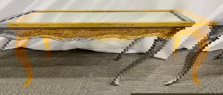 Regency Coffee Table, Giltwood, Mirror Top: Petite Hollywood Regency Style Coffee Table, Giltwood Base, Antiqued Mirror TopSmall wooden coffee table by an unknown French designer having decorative carved wooden legs in a distressed gilt and an